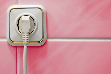 Image showing white outlet on a red wall