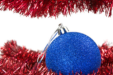 Image showing Christmas tinsel and blue bauble