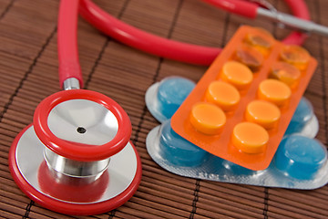 Image showing  pills and red stethoscope