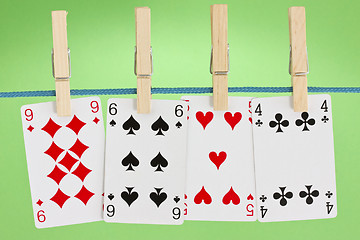 Image showing playing cards hung on clothesline