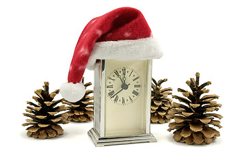 Image showing clock with Santa hat and pine cones