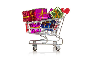 Image showing Shopping  cart with colorful gift boxes