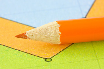 Image showing orange pencil on the colorful paper