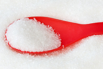 Image showing red spoon with sugar