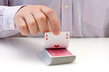 Image showing hand lifting up playing card