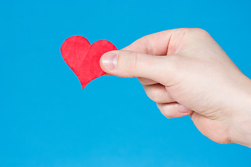 Image showing Hand with heart on blue background