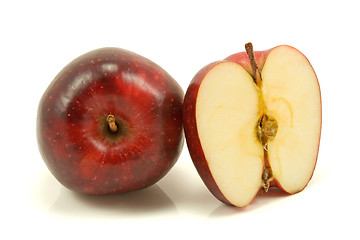 Image showing apple and half over a white background