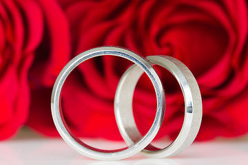 Image showing two silver rings with red roses