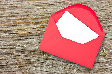 Image showing Red envelope on wooden background