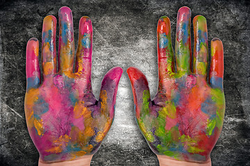 Image showing painted human hands on dark background