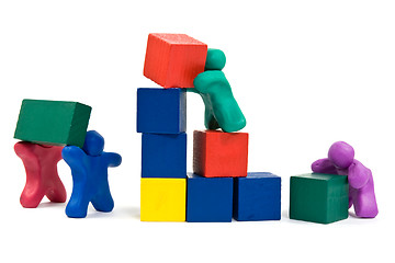 Image showing  plasticine people building wooden blocks