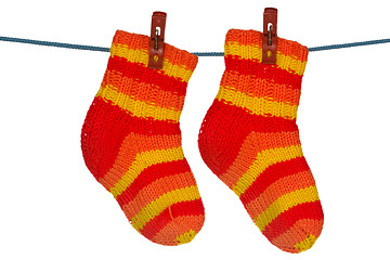 Image showing Knitted socks hung on the rope