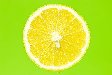 Image showing Lemon slice on green background