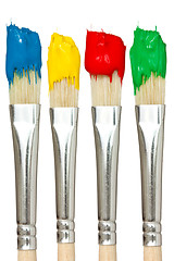 Image showing Four paintbrushes with color paints