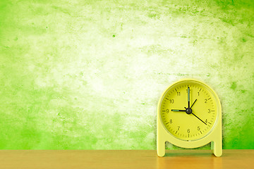 Image showing green clock against dirty wall background