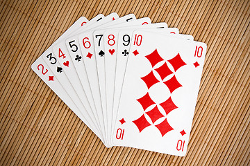 Image showing playing cards on bamboo background