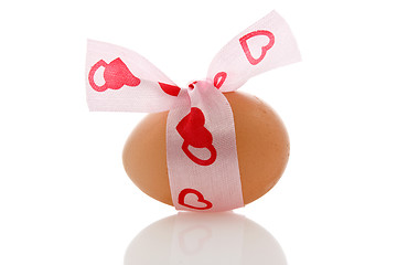 Image showing brown egg with a ribbon