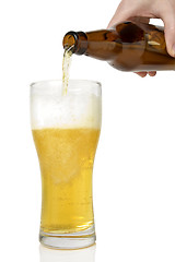 Image showing Beer pouring from bottle into glass