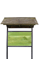 Image showing Green wooden billboard with old roof