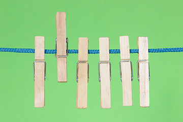 Image showing Clothes pegs  on the green background