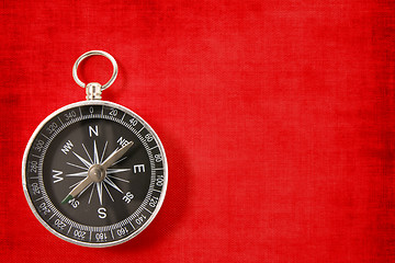 Image showing compass on the vivid red background