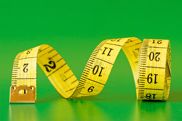 Image showing  measure tape on green background