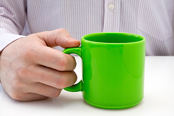Image showing businessman hold a green cup