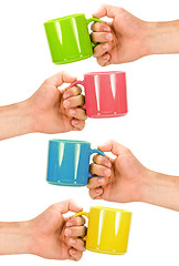 Image showing four hands with colorful cups