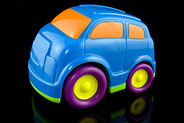 Image showing blue plastic car on black background