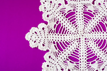 Image showing white decorative serviette on purple background