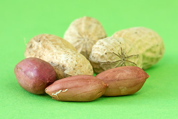 Image showing peanuts over a green background