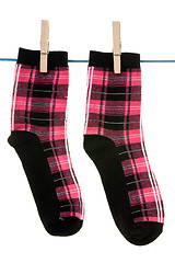 Image showing two socks hang on rope