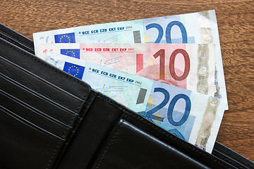 Image showing wallet with euros on the table