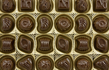 Image showing chocolate pralines in a golden box