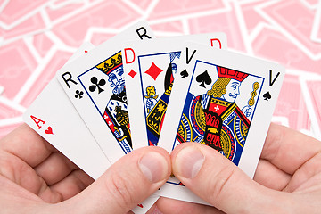 Image showing hands holding four playing cards