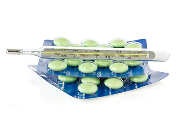 Image showing Thermometer and green pills
