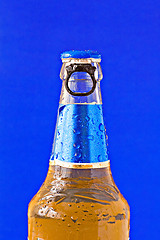 Image showing bottle of beer on blue background