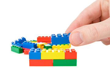 Image showing hand build a color plastic  bricks