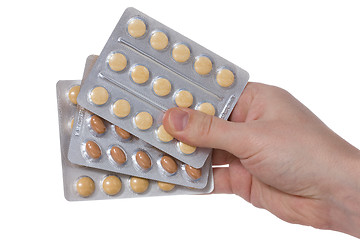Image showing Medical pills containers in a  hand