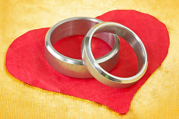 Image showing wedding rings on paper heart