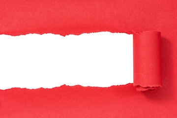 Image showing Hole ripped in red paper