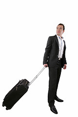 Image showing Young business man walking on white background with his trolley 