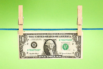 Image showing dollar hung  over a green background