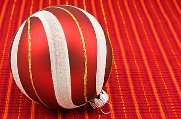 Image showing christmas bauble on red decorative background