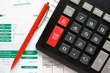 Image showing calculator,pen and the financial reports