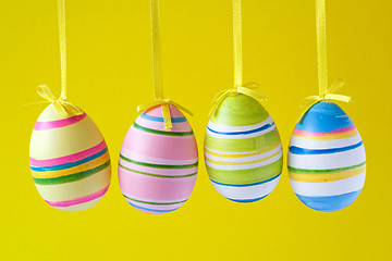 Image showing easter eggs hung on yellow background