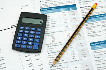 Image showing calculator,pencil and tax form