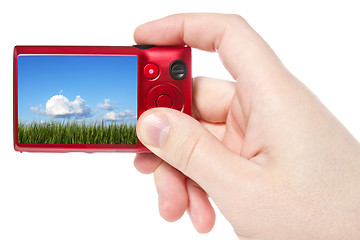 Image showing hand hold camera with  picture of nature