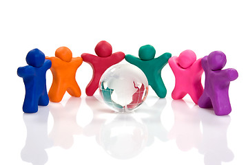 Image showing plasticine people  surrounding a crystal globe