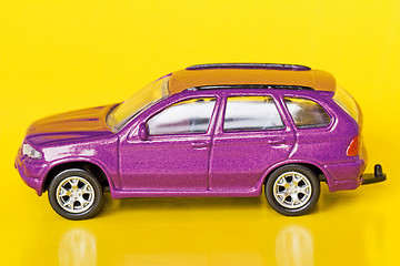 Image showing purple car  on yellow background